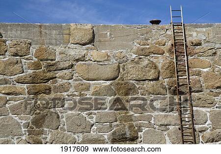 Stock Photo - Ladder On Stone Wall. Fotosearch