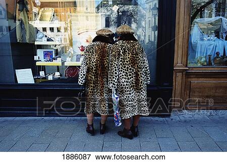 Stock Photo - Ladies In Matching Fur Coats Window Shopping In The Old Town. Fotosearch