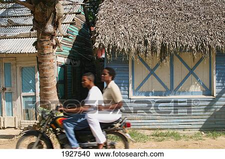 Stock Image - Ladies On Bike. Fotosearch