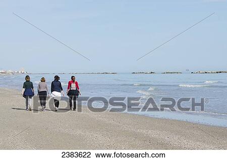 Ladies walking on the sea shore; Porto San Giorgio, Marche, Italy View Large Photo Image Stock Image - Ladies walking on the sea shore; Porto San Giorgio, Marche, Italy. Fotosearch