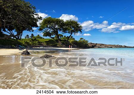 Picture - Lady in red walks along Kauna'oa Beach; Island of Hawaii, Hawaii, United States of America. Fotosearch