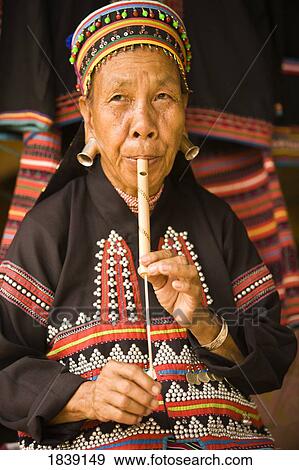Stock Photo - Lahu Shi Balah Tribeswoman Playing Instrument; Chiang Mai, Thailand. Fotosearch