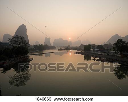 Stock Image - Lake In Mountains At Sunset. Fotosearch