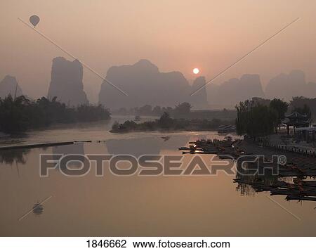 Lake In Mountains At Sunset; Yulong River, Yangshuo, China View Large Photo Image Stock Image - Lake In Mountains At Sunset; Yulong River, Yangshuo, China. Fotosearch