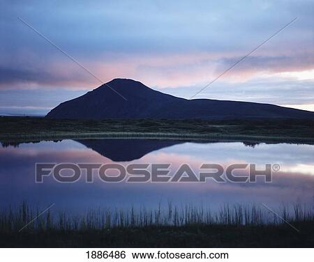 Stock Photograph - Lake Myvatn At Sunset With Mountains Reflected In Water. Fotosearch