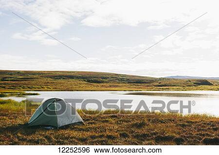 Stock Photograph - Lakeside tent at sunrise, Denali National Park; Alaska, United States of America. Fotosearch