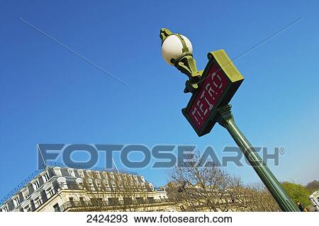 Stock Image - Lamp post and sign for the metro; Paris, France. Fotosearch