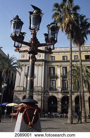 Stock Image - Lamp Post In An Urban Area With A Bird Sitting On Top Of A Lamp. Fotosearch