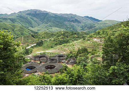 Landscape of Tulou buildings in a village from Hakka minority group were built eight centuries ago; Yongding, Fujian province, China View Large Photo Image Stock Image - Landscape of Tulou buildings in a village from Hakka minority group were built eight centuries ago; Yongding, Fujian province, China. Fotosearch