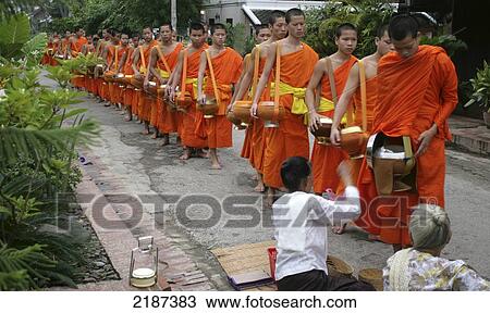 Stock Image - Laos, Luang Prabang Monks Collecting Donations Of Food At Dawn From Towns People. Fotosearch