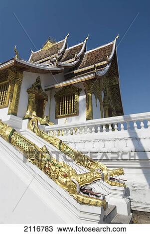 Stock Image - Laos, Luang Prabang, Wat Sen, Architectural detail of dragpns along side of building.. Fotosearch