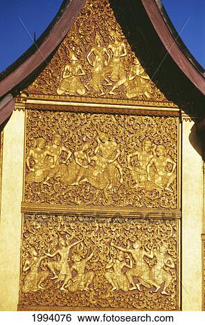 Stock Photograph - Laos, Luang Prabang, Wat Xien Thong, Intricately Carved Temple Wall.. Fotosearch