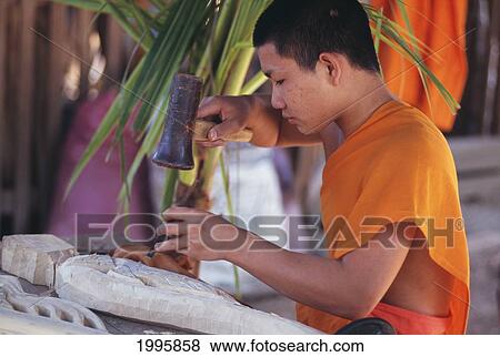 Laos, Luang Prabang, Young Monk Carving A Wood Filigree. View Large Photo Image Stock Photo - Laos, Luang Prabang, Young Monk Carving A Wood Filigree.. Fotosearch