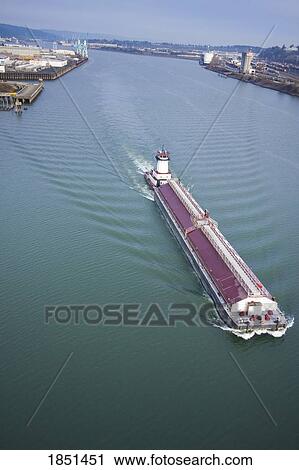 Stock Image - Large Boat Sailing Through Water. Fotosearch