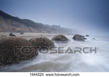 Large Boulders In The Shallow Water Along The Beach; Moeraki South Island New Zealand View Large Photo Image Stock Photography - Large Boulders In The Shallow Water Along The Beach; Moeraki South Island New Zealand. Fotosearch