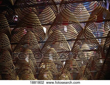 Stock Image - Large Coils Of Incense Hanging From The Ceiling Of Man Mo Temple. Fotosearch
