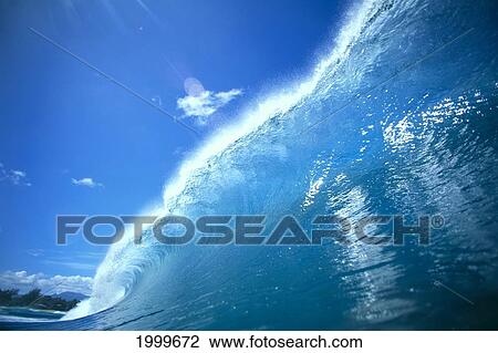 Stock Image - Large Glassy Wave With Sun Reflections, Blue Sky, Whitewash C1742. Fotosearch