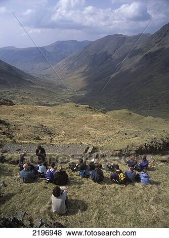 Stock Photo - Large Group Of Walkers Resting On The Way Up Scafell Pike, Lake District, Uk.. Fotosearch