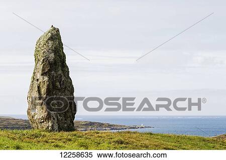 Large megalithic rock in grassy field overlooking bay with hazy blue sky; Clifden, County Galway, Ireland View Large Photo Image Stock Photography - Large megalithic rock in grassy field overlooking bay with hazy blue sky; Clifden, County Galway, Ireland. Fotosearch