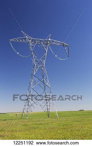 Large metal electrical tower in a green field with blue sky; Alberta, Canada View Large Photo Image Stock Image - Large metal electrical tower in a green field with blue sky; Alberta, Canada. Fotosearch