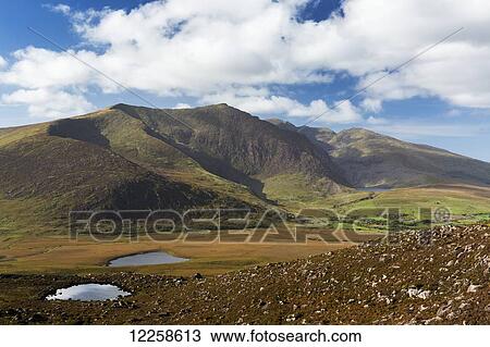 Large mountain with two lakes with clouds and blue sky; Dingle, County Kerry, Ireland View Large Photo Image Stock Image - Large mountain with two lakes with clouds and blue sky; Dingle, County Kerry, Ireland. Fotosearch
