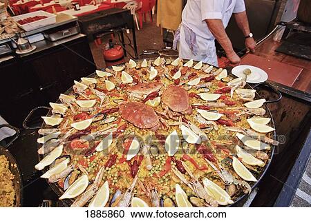 Stock Image - Large Paella Being Cooked At Snack Bar. Fotosearch