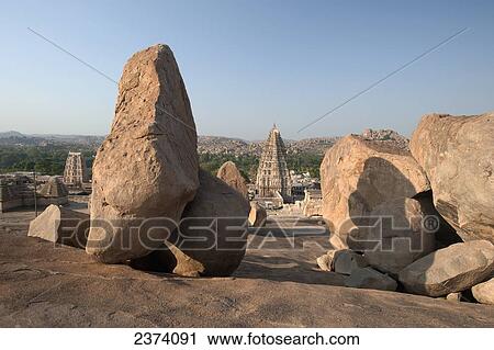 Large rocks with religious buildings in the background; Hampi, Karnataka, India View Large Photo Image Stock Image - Large rocks with religious buildings in the background; Hampi, Karnataka, India. Fotosearch