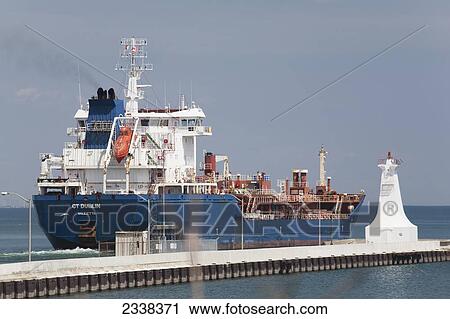 Large Ship With Small White Lighthouse At The End Of A Pier In A Lake With Blue Sky; Burlington, Ontario, Canada View Large Photo Image Stock Image - Large Ship With Small White Lighthouse At The End Of A Pier In A Lake With Blue Sky; Burlington, Ontario, Canada. Fotosearch