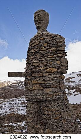 Stock Image - Large stone statue of a viking on top of a mountain pass; Iceland. Fotosearch
