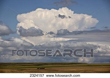 Stock Photo - Large thunderhead forms over the prairies on a hot humid afternoon; Saskatchewan, Canada. Fotosearch
