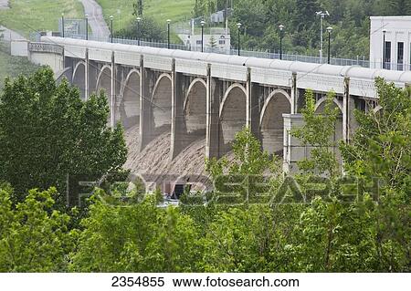 Stock Photography - Large Volume Of Water Flowing After A Flood; Calgary, Alberta, Canada. Fotosearch
