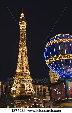 Stock Image - Las Vegas, Nevada, United States Of America; Eiffel Tower And Air Balloon Sign Illuminated At Night. Fotosearch