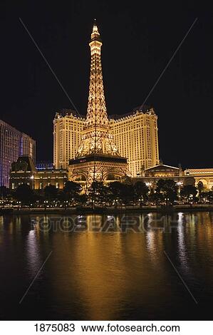 Stock Image - Las Vegas, Nevada, United States Of America; Eiffel Tower And Hotel Illuminated At Night And Reflecting In The Pool. Fotosearch