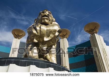 Stock Photography - Las Vegas, Nevada, United States Of America; A Lion Statue And Male Figures Holding Bowls. Fotosearch