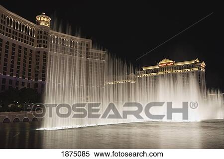 Stock Photography - Las Vegas, Nevada, United States Of America; Water Fountain Pool Illuminated At Night With Hotels In The Background. Fotosearch
