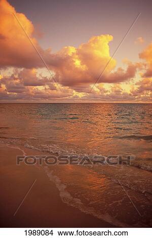 Picture - Late Afternoon Light Sreflects Pink Clouds On A Calm Ocean.. Fotosearch