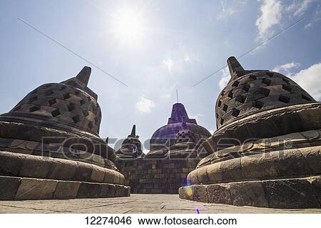 Latticed stone stupas containing Buddha statues on the upper terrace, Borobudur Temple Compounds, Central Java, Indonesia View Large Photo Image Stock Photograph - Latticed stone stupas containing Buddha statues on the upper terrace, Borobudur Temple Compounds, Central Java, Indonesia. Fotosearch
