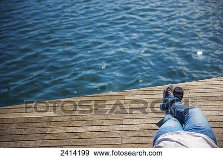 Laying down on a wooden dock at the water's edge; Barcelona, Spain View Large Photo Image Stock Photo - Laying down on a wooden dock at the water's edge; Barcelona, Spain. Fotosearch