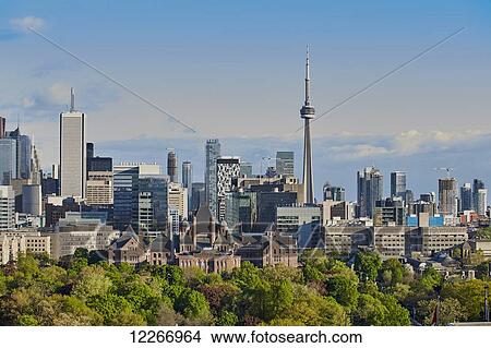 Leafy trees against city skyline; Toronto, Ontario, Canada View Large Photo Image Picture - Leafy trees against city skyline; Toronto, Ontario, Canada. Fotosearch