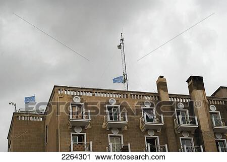 Stock Image - Ledra palace hotel now un building behind barbed wire; nicosia cyprus. Fotosearch