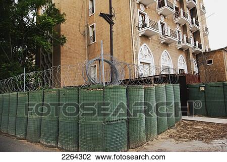 Stock Image - Ledra palace hotel now un building behind barbed wire; nicosia cyprus. Fotosearch