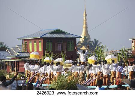 Stock Image - Leg rowing procession on Inle Lake; Myanmar. Fotosearch
