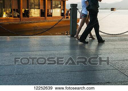 Legs of a couple walking around of famous West Lake; Hangzhou, Zhejiang, China View Large Photo Image Stock Photo - Legs of a couple walking around of famous West Lake; Hangzhou, Zhejiang, China. Fotosearch