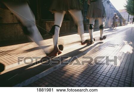 Stock Image - Legs Of Men Walking In Traditional Dress. Fotosearch