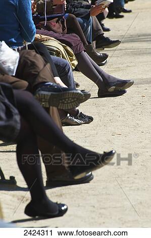 Legs of people sitting in a row; Paris, France View Large Photo Image Stock Image - Legs of people sitting in a row; Paris, France. Fotosearch