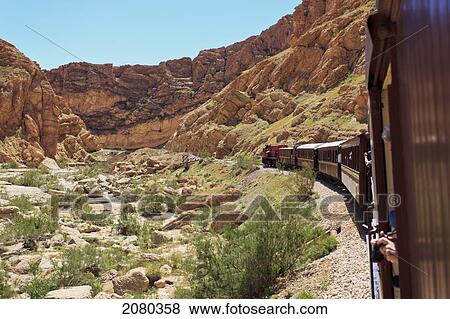 Stock Photo - Lezard Rouge Train Runs From Metlaoui To Redeyef And Passes Through The Selja Gorge; Tunisia, North Africa. Fotosearch