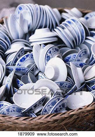 Stock Photo - Lids & Saucers Of Tea Cups In Straw Basket In Tea House, Bamboo Park. Fotosearch