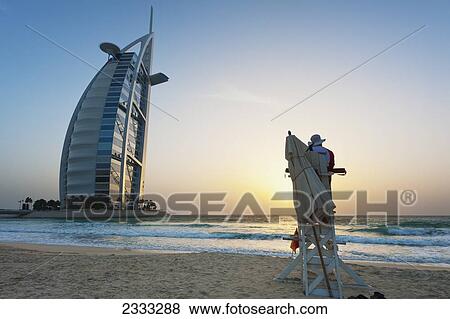 Lifeguard On Beach At Dusk In Front Of The Burj Al Arab; Dubai, United Arab Emirates View Large Photo Image Stock Photo - Lifeguard On Beach At Dusk In Front Of The Burj Al Arab; Dubai, United Arab Emirates. Fotosearch