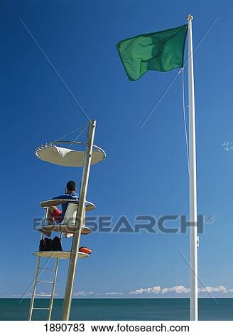 Lifeguard Sitting At Tower On Beach View Large Photo Image Stock Image - Lifeguard Sitting At Tower On Beach. Fotosearch