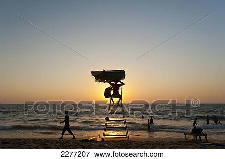 Stock Photo - Lifeguard tower at sunset on beach; Goa, India. Fotosearch